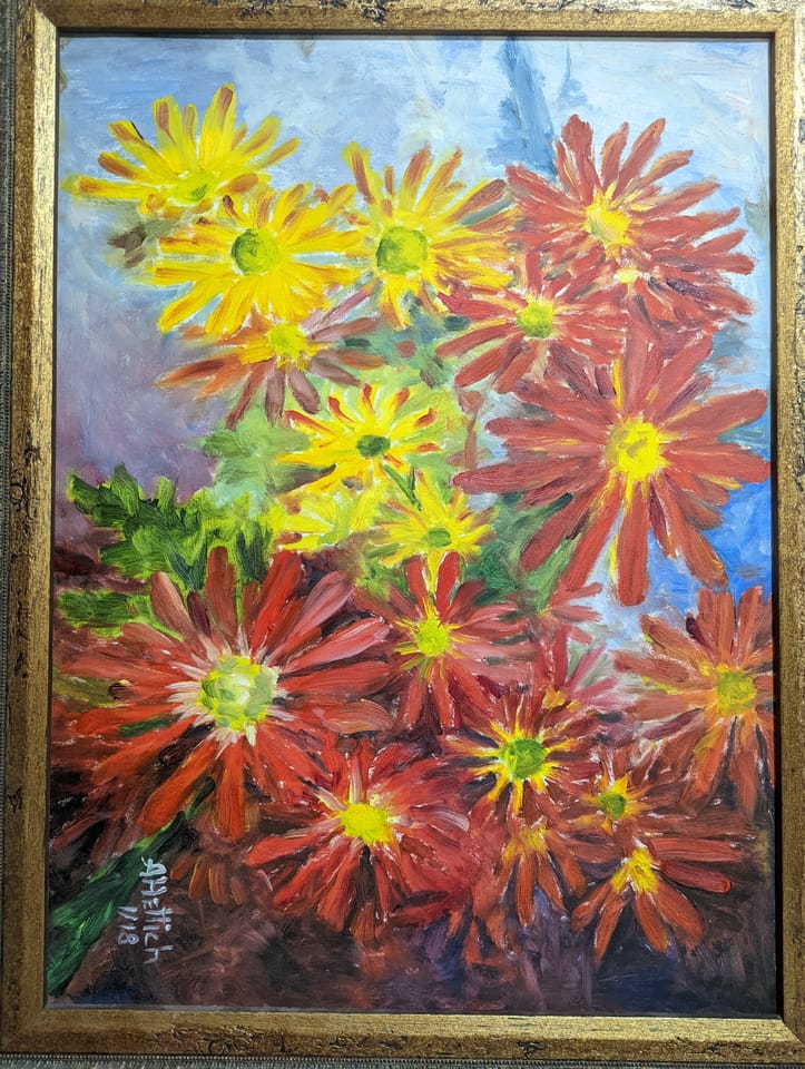 A painting of red and yellow daisies in a gold frame, signed A. Hettich 11/18.